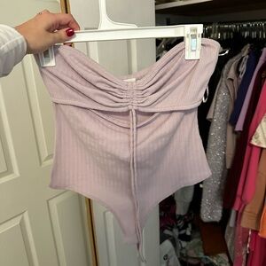 Lelis- worn once- purple body suit with cut out and cinch